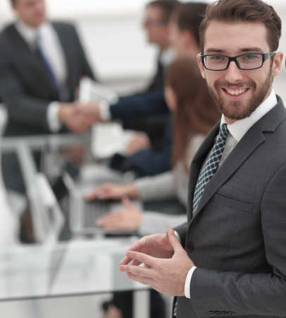 smiling businessman on background of office