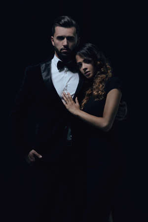 portrait of fashion couple on black backgroundの写真素材