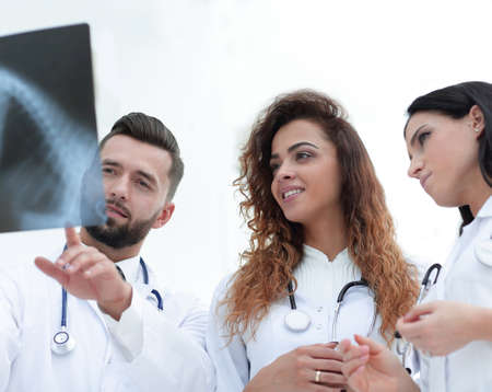 group of medical workers looking at patients x-ray film