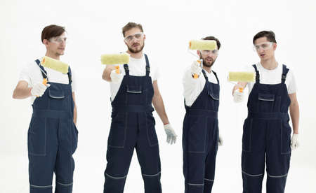 team of builders with paint rollersの写真素材