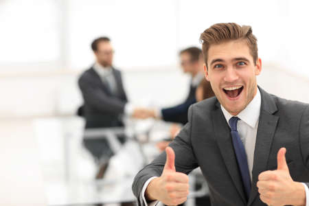 Portrait of happy energetic businessman with thumbs up while  coの写真素材