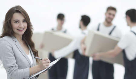 Businessman with documents, creating a stack of cardboard boxes.の写真素材