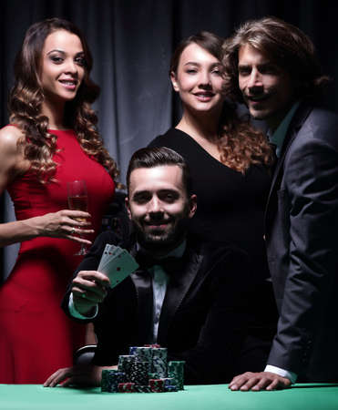 adult group celebrates a friends victory in pokerの写真素材