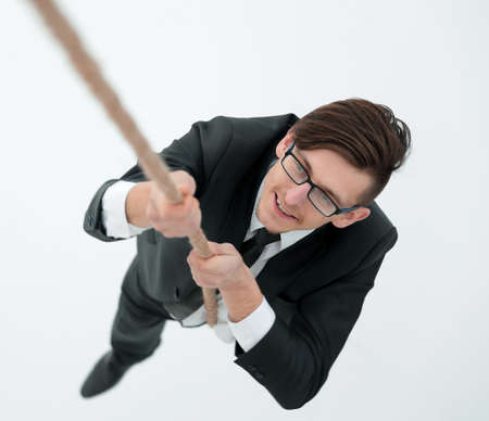 successful businessman climbing the rope