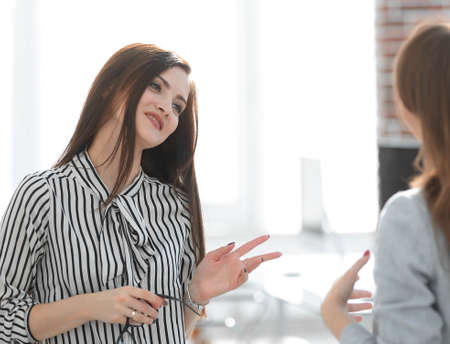 two young employees are talking in the office.の写真素材