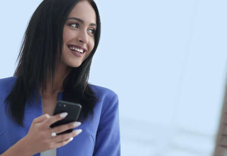 Young businesswoman with mobilephoneの写真素材