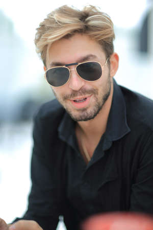 Businessman sitting in park using mobile phoneの写真素材