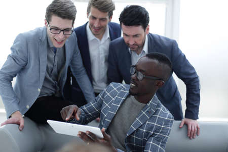 business team discusses the information using a digital tabletの写真素材