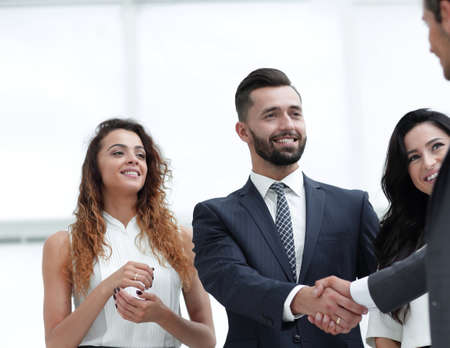 handshake business partners in the office.
