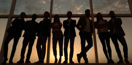 in full growth. business team standing near the office windowの写真素材