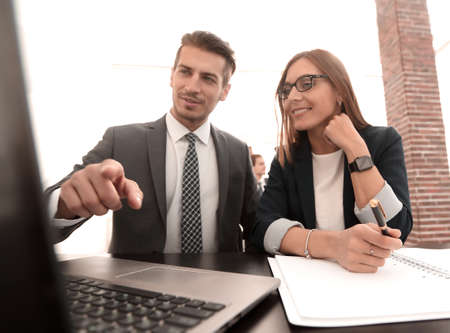 Two successful partners working with a laptop