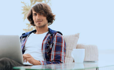 serious guy working sitting near the desktop.