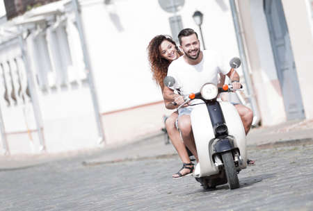 Cool man and beautiful girl riding on  scooter with  expressionの写真素材