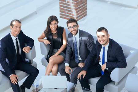 portrait of successful business team sitting in office lobbyの写真素材