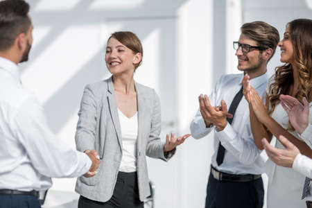 business woman welcomes the business partners handshakeの写真素材