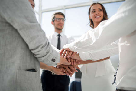 close up. business team with hands folded togetherの写真素材