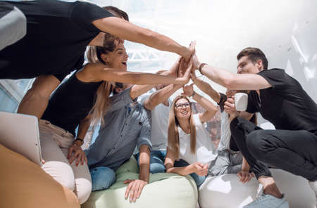 team of young people giving a high five
