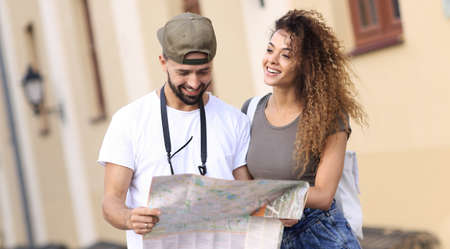 Young tourist couple with map looking for a way