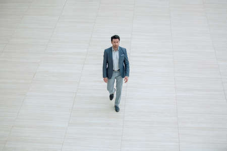businessman confidently steps forwardの写真素材