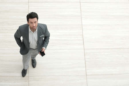 top view.businessman with smartphone looking at the cameraの写真素材