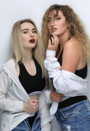 Two young girl friends smiling