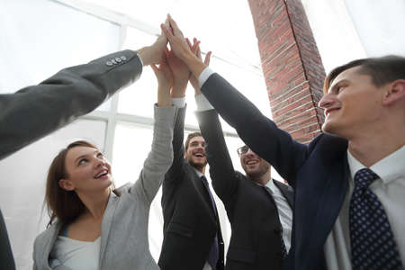 Business people with their hands together in a circle