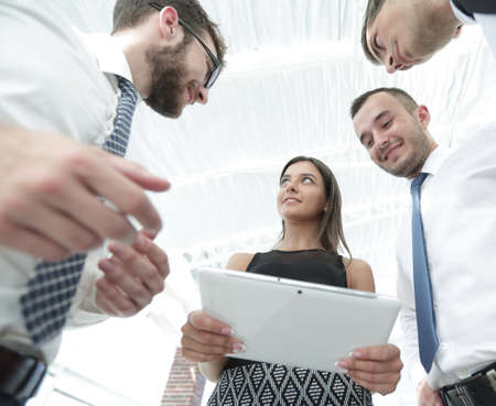 bottom view of business team looking at digital tabletの写真素材