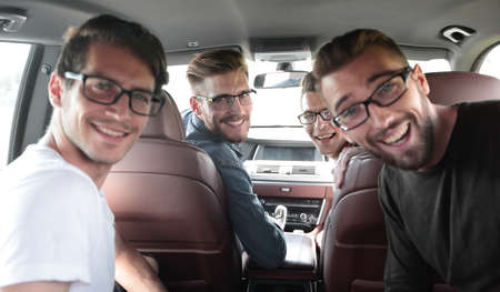 close up. a group of friends sitting in the car
