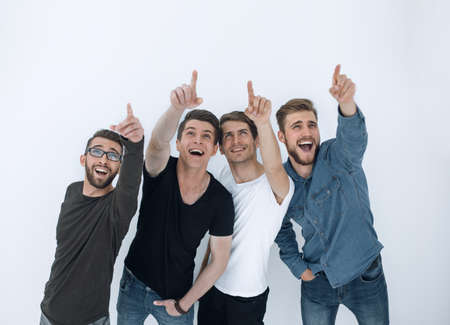 group of surprised young people looking and pointing upの写真素材