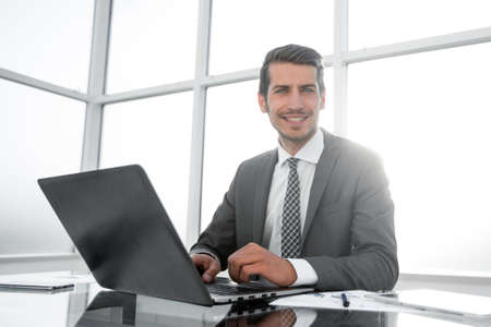 smiling businessman sitting at his Deskの写真素材