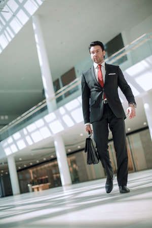 businessman walking near the office buildingの写真素材