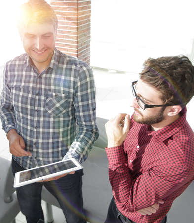 Two Men Using Tablet Computer In Creative Office Two Men Using Tablet Computer In Creative Office