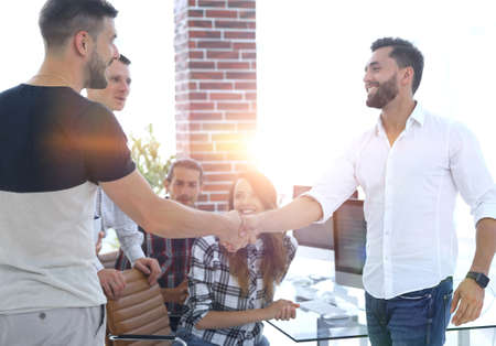 welcome handshake colleagues in creative office
