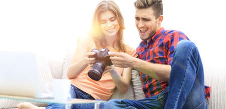happy young couple checks photos on photos the camera