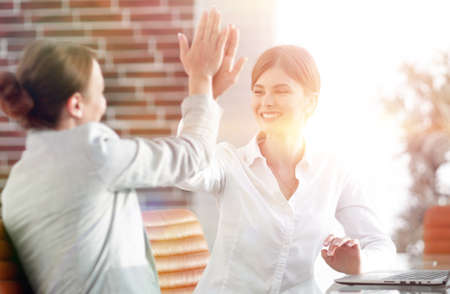 members of the business team giving each other a high five.