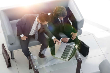 business colleagues discussing data from the laptop.