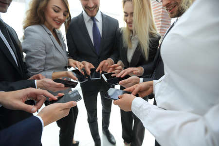close-up of smartphones in the hands of business youthの写真素材