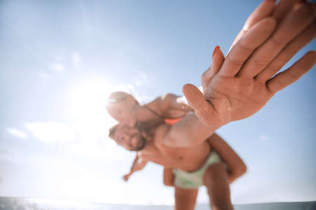 Handsome man giving piggy back to his girlfriend.の写真素材