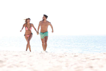 Happy lovers playing with each other on the beach.の写真素材