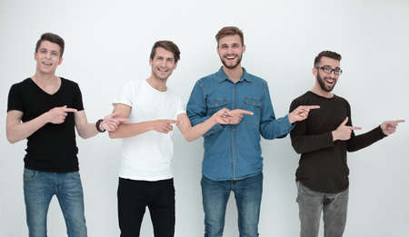 cheerful group of friends showing their fingers to the sideの写真素材