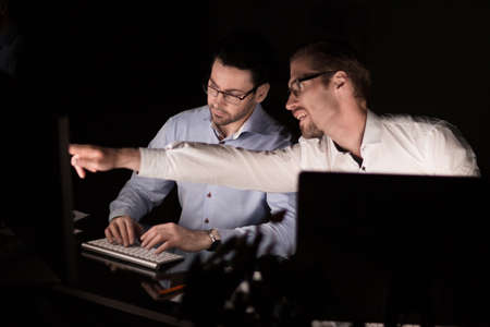 close up.two employees work in the eveningの写真素材