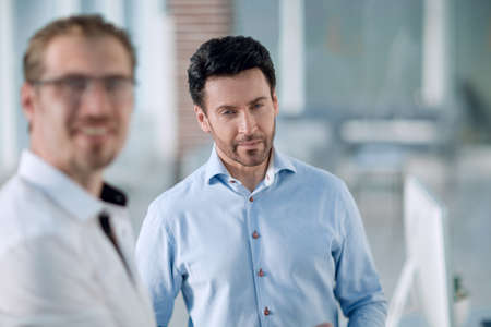 businessman talking to a colleague in the officeの写真素材