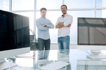business background.two employees standing in a modern office.の写真素材