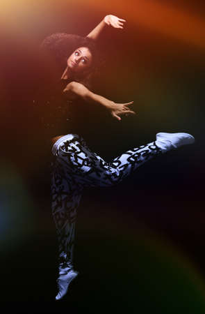 Teenage girl dancing hip-hop at studio.