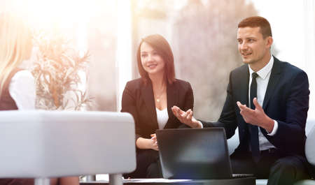 business team talking in office lobbyの写真素材