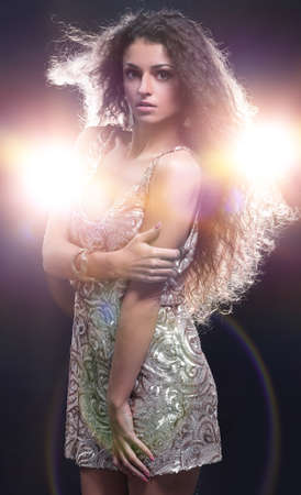 Young dancing woman, with flashes on backgroundの写真素材