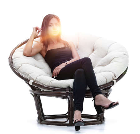 young woman sitting in comfortable round big chair