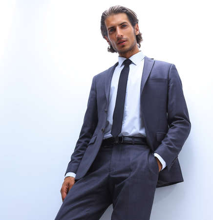 businessman is leaning on a white wallの写真素材
