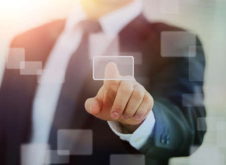 business man pressing a touchscreen button.の写真素材