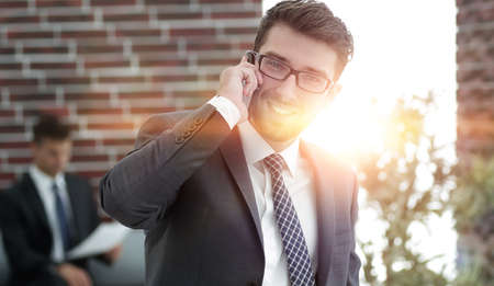 businessman talking on smartphone in his officeの写真素材